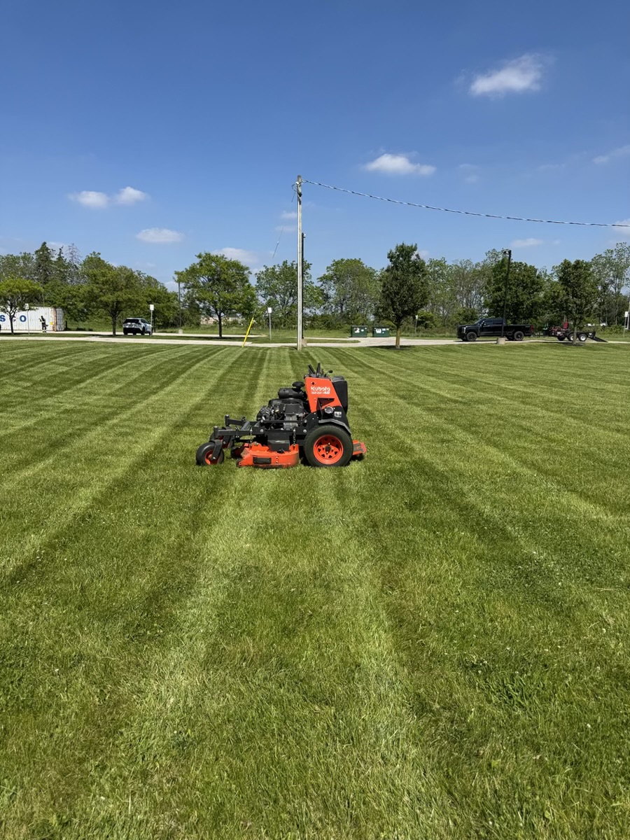 Professional mower creating clean stripes across a maintained lawn