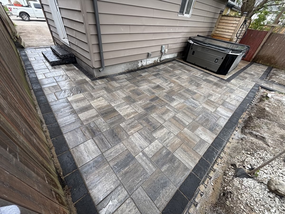 New interlocking paver patio beside a home